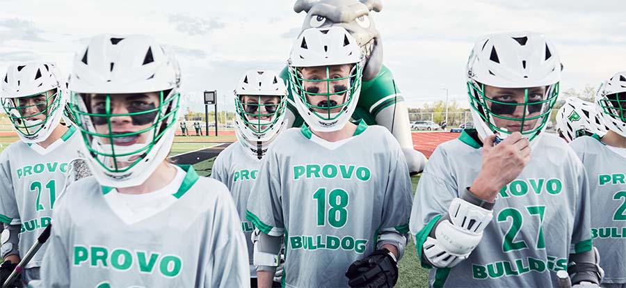 PHS boys lacrosse players walking towards cameera from inflatable bulldog